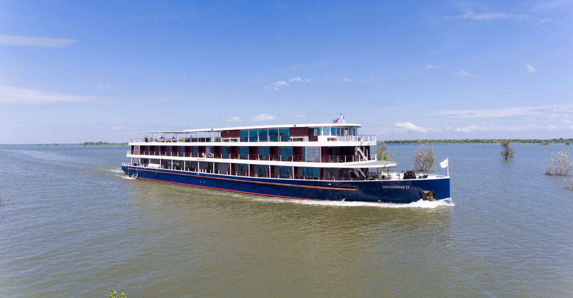 River cruise ship sailing past vineyards near Rudesheim on the Rhine